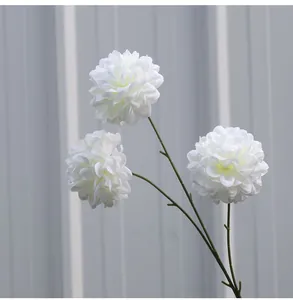 Detailansicht von drei eleganten weißen künstlichen Ball-Chrysanthemen an einem Zweig