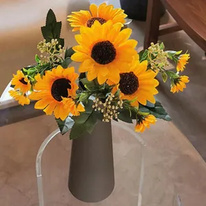 Detailed view of vibrant artificial sunflowers in a minimalist gray vase for home decor.