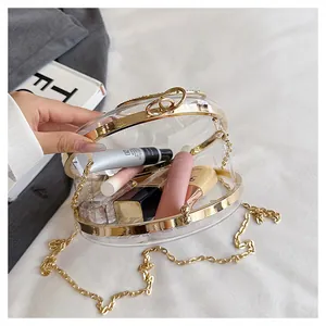 Detailed view of the interior capacity of a transparent round gold-framed bag.