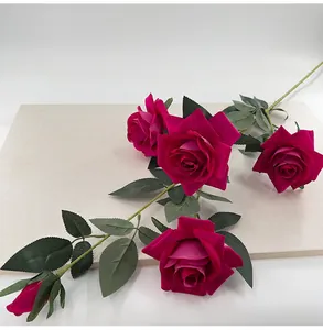 Detailed view of a 5-headed magenta velvet artificial rose with textured green leaves