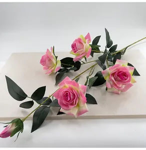 Detailed view of 5-head pink velvet artificial roses with realistic green leaves