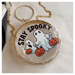 Close-up of clear acrylic round crossbody bag with Stay Spooky ghost and pumpkin design