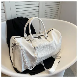High-quality white travel bag with crocodile texture and decorative chain strap details
