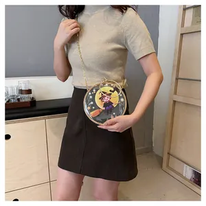 Detail of transparent round crossbody bag with cute witch illustration and gold chain