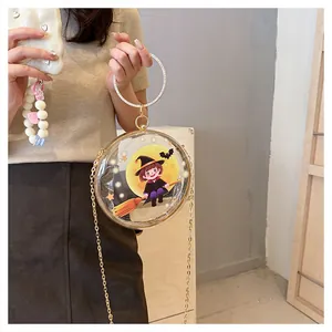 Close-up of a unique transparent round bag featuring a cartoon witch design and chain strap.