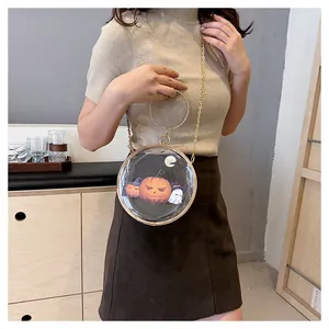 Model wearing a transparent round crossbody bag featuring Halloween pumpkin and ghost art