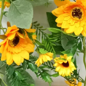 Detailed view of vibrant yellow artificial sunflower vine garland for wall decor