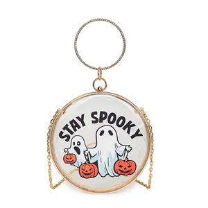 Detail of transparent round clutch with ghost pumpkin print and stay spooky text