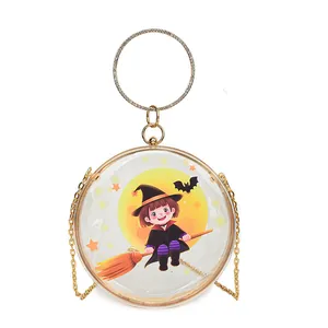Close-up of a round transparent handbag featuring a cartoon witch and gold handle