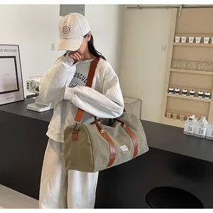 Große olivgrüne Reisetasche aus Canvas für Fitness und Wochenendausflüge am Modell