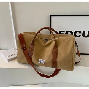 Detailansicht einer großen Reisetasche aus Segeltuch mit braunen Riemen