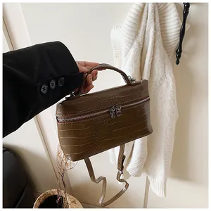 Brown crocodile embossed box handbag with silver-tone hardware detail.