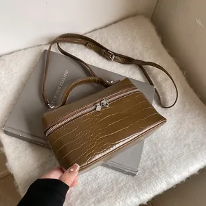 Minimalist brown crocodile embossed box bag with top handle and adjustable strap