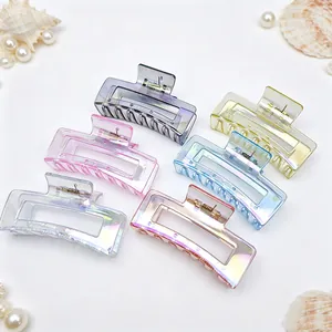 Detail view of six iridescent hair claw clips in various colors on a white background.