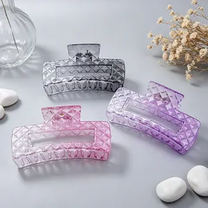 Macro view of three gradient colored hair claw clips featuring a stylish diamond texture