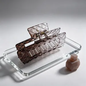 Close-up of a high-end brown quilted texture large square hair claw clip on a tray