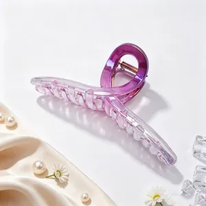 Detail of a 13cm purple gradient UV plated hair claw clip on silk fabric with pearls.