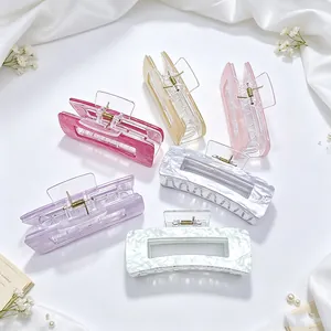 Detailed view of large acrylic hair claw clips with elegant marble textures and pastel hues
