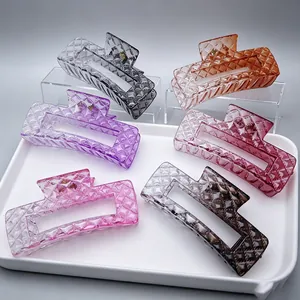 Close-up detail of large gradient hair claw clips with elegant quilted diamond pattern