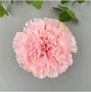 Detailed top view of a pink artificial carnation flower head with realistic petals