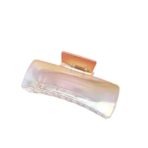 Detailed view of large gradient iridescent hair claw clip with glossy square design