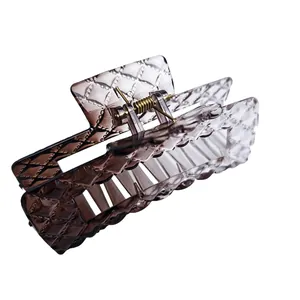 Detail view of a large gradient square hair claw clip with quilted leather look texture