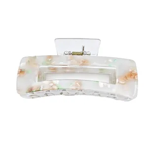 Close-up of elegant acrylic hair claw clip with colorful floral mosaic pattern on white background