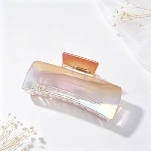 Close-up of a gradient iridescent square hair claw clip with metallic finish.