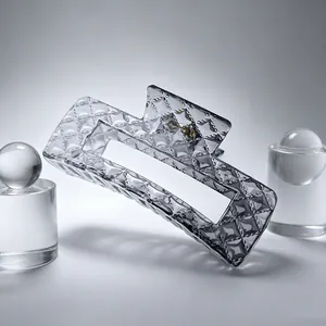 Detailed view of the large square gradient grey hair claw clip with diamond quilted texture