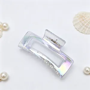 Close-up of elegant iridescent rectangular hair claw clip with decorative pearls