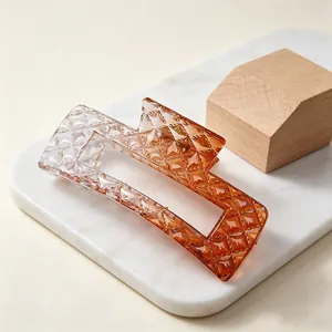 Detailed view of large gradient amber hair claw clip featuring a quilted diamond texture