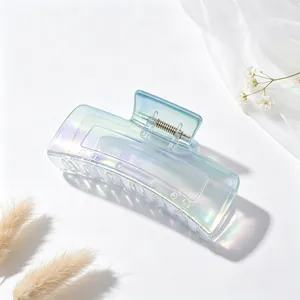 Macro detail of the iridescent gradient finish on a large square-shaped hair claw clip.