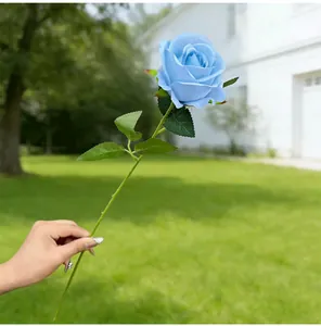 Close-up of a single stem artificial blue rose for home and wedding decor