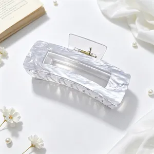 Close-up detail of large acrylic hair claw clip with elegant grey marble pattern