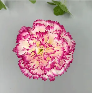 Detailed top-down view of artificial carnation head with vibrant magenta petals edges