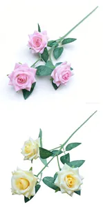 Detailed view of pink and cream artificial multi-head roses with green leaves