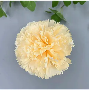 Close-up of a light yellow artificial carnation flower head for wedding DIY decor