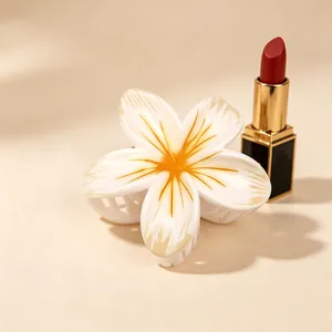 Elegant white and orange Plumeria flower hair claw clip with a glossy UV finish for updos