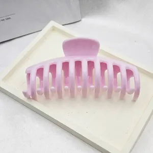 Close-up detail shot of a large pink hair claw clip with dragon bone design for women.