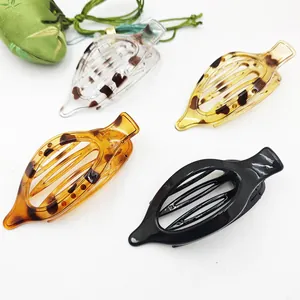 Assorted set of four large leopard print and solid flat hair claw clips for women.