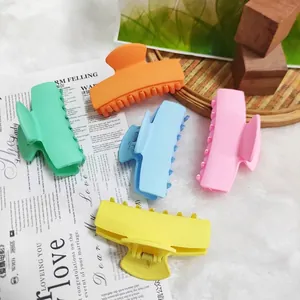 Detailed view of matte rectangular hair claw clips in five vibrant dopamine colors