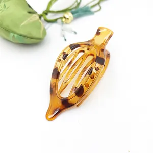 Close-up of flat tortoiseshell hair clip with elegant leopard pattern detail