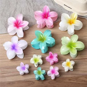 Colorful plumeria flower hair claw clips in various sizes for summer vacation