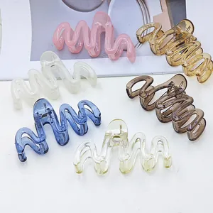 Detailed view of jelly-colored wavy hair claw clips in various pastel shades