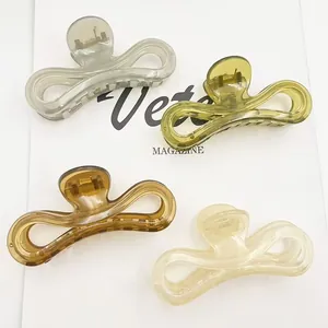 Group of four jelly colored minimalist large shark hair clips on a white background.