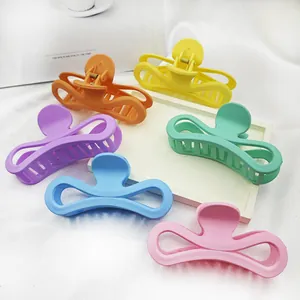 Large matte hair claw clips in various pastel colors featuring a unique bow hollow design