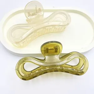 Detail of translucent jelly-colored shark hair clips on a white decorative tray