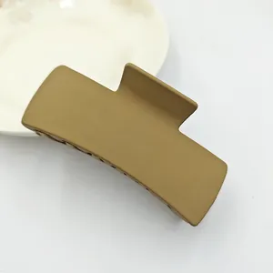 Close-up of a large matte square hair claw clip in a solid earthy olive green finish