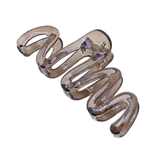 Close-up detail showing the unique wavy design and jelly brown texture of this hair claw