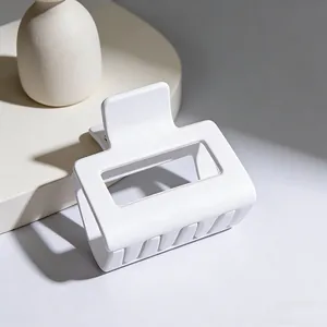 Close-up macro view of a large minimalist matte white square hair claw clip detail